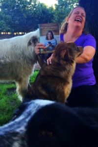 Andrea Gage with her dogs licking her Andrea Gage with her dogs licking her